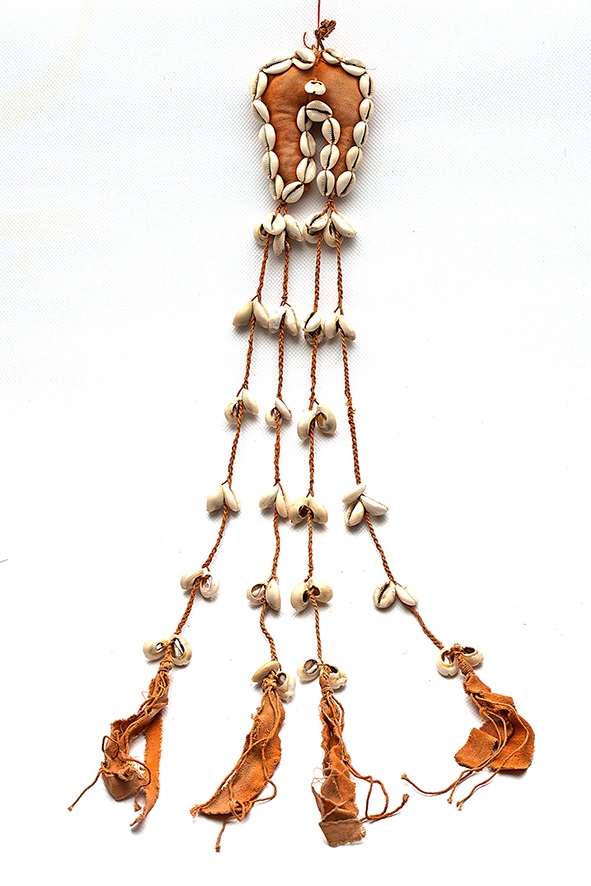 Protective sign, busug, cotton material, ornamented with cowry shells. Toshke, W. Neja Dukki Daur, 1964 (Photographed by the author).